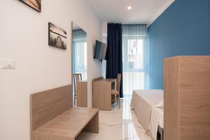 a hotel room with a bed and a mirror at Hotel Marconi Express in Bologna