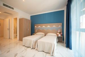 Posteľ alebo postele v izbe v ubytovaní Hotel Marconi Express