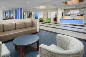 a lobby with a couch and chairs and a table at Holiday Inn Express - Tullahoma, an IHG Hotel in Tullahoma