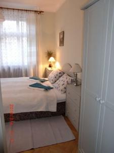 a small bedroom with a bed and a window at Villa Adam in Prague