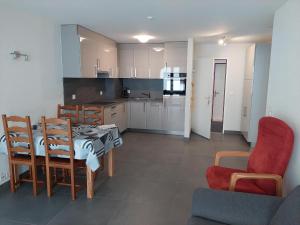 a kitchen and dining room with a table and chairs at Haus Fortuna in Leukerbad