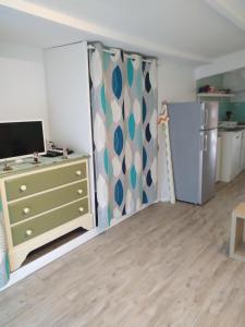 a living room with a dresser and a refrigerator at Marie in Aytré