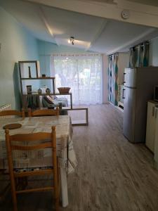 a living room with a table and a refrigerator at Marie in Aytré