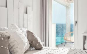 a bedroom with a bed and a large window at Villa Bianca Luxury B&B Experience in Santa Teresa Gallura