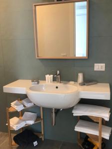 a bathroom with a white sink and a mirror at Verde Matematico in Vico del Gargano +36 photos