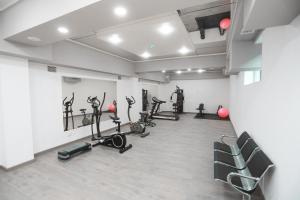 a gym with several treadmills and exercise bikes at Reikartz Amirun Tashkent in Tashkent