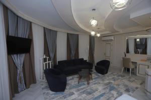 a living room with a couch and a table at Reikartz Amirun Tashkent in Tashkent