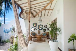 a room with a table and chairs and plants at De'Coco Villa in Gili Air
