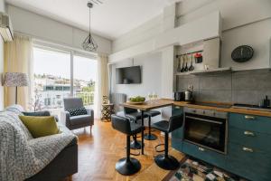 アテネにあるErato by Heloni Apartmentsのキッチン、リビングルーム(テーブル、椅子付)