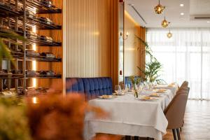 a long dining room with a long table with chairs at Amare Hotel in Shëngjin