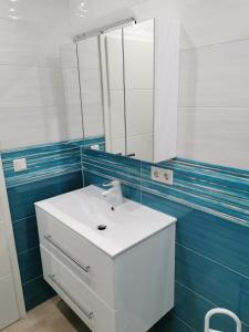 a bathroom with a white sink and a mirror at Gästehaus Anglerklause in Allstedt