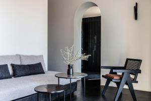 a living room with a couch and a table at Nimbus Santorini in Oia