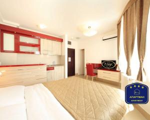 a bedroom with a large bed and a kitchen at Wing Club Dajana in Jagodina