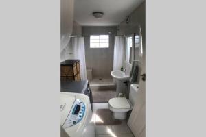 a bathroom with a toilet and a sink at Newlands East, Durban Home, Panoramic•Peaceful• in Duffʼs Road
