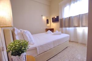 A bed or beds in a room at Athena hotel