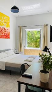 A bed or beds in a room at The Roof Garden - Bed&Breakfast