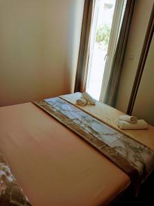 a bed in a room with a window at Apartment Maxim in Primošten
