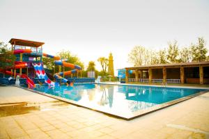 a large swimming pool with a water slide at Lighthouse Waterpark and Resort in Mansar