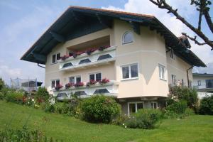 a large white building with flowers on the balconies at Appartement Alpenblume in Schladming