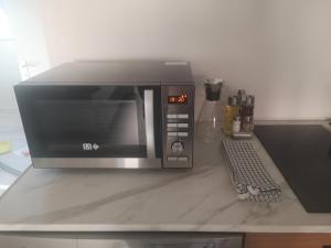 a microwave sitting on top of a counter at Centre ville historique - calme - les mots bleus in Besançon