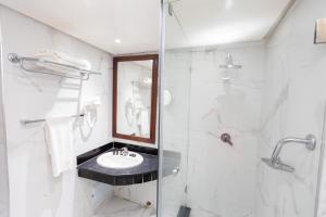 a bathroom with a sink and a shower at Hotel Majestic in Casablanca