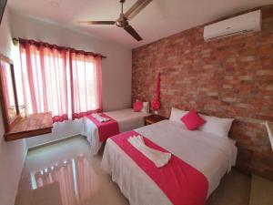 Postel nebo postele na pokoji v ubytování Villas del Carmen Holbox