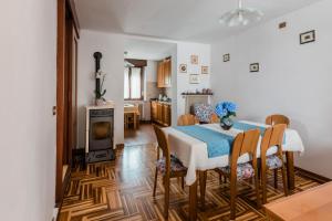 a dining room with a table and chairs and a fireplace at Dimora Augusto & Valentina in Maiano