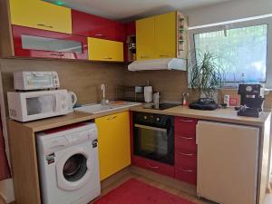 a kitchen with a washing machine and a microwave at Studio Yana *Top location*Sea Garden* in Varna City