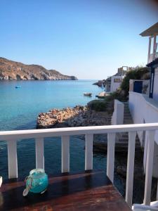 a view of the ocean from the balcony of a house at Salty Kisses and Sandy Toes in Firopótamos