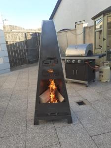 a fire oven on a patio with a grill at Mussenden House in Articlave