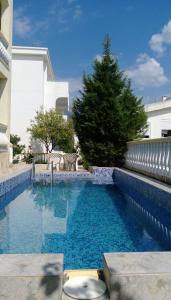 a swimming pool in front of a building at Apartment Barski in Bar