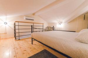 a bedroom with a large bed and a wooden floor at Casa Mia apartment in Vodnjan