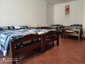 a room with three beds and a table at Affittacamere “Del Ponte” in Cartignano