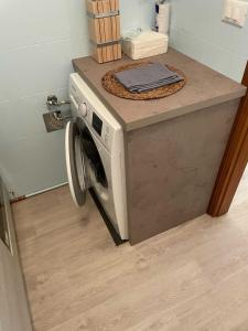a washing machine with a counter on top of it at Casa Anemos in Grado