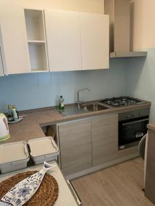 a kitchen with a sink and a stove at Casa Anemos in Grado