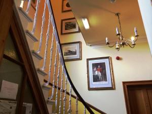 a wall with pictures of people on it at Bellevue Guest House in Edinburgh