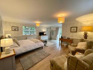 a bedroom with a bed and a living room at The Garden Room at Sleepy Hollow in Louisburgh