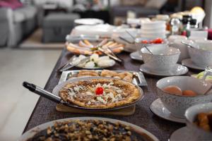 a table topped with food and bowls of food at Aegean Castle Andros – Adults Only in Agia Eleousa