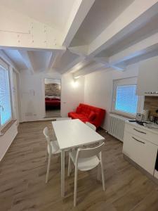 a living room with a table and a red couch at La Corte Residence in Fabriano