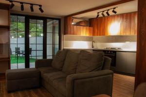 a living room with a couch and a kitchen at Likani Home in Borjomi