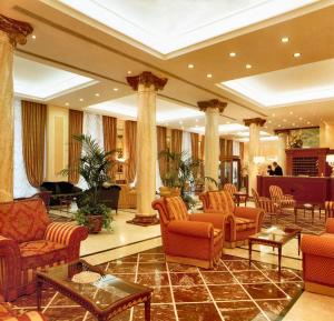 a lobby with couches and chairs and a table at Andreola Central Hotel in Milan