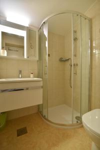 a bathroom with a shower and a sink at Apartmani Badurina - Crnika in Lun