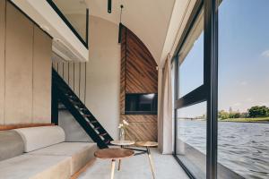 a room with a view of the water at New Port Apartments on the River in Krakow