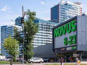 a novus sign on a building in a city at ORION apartments in Kyiv