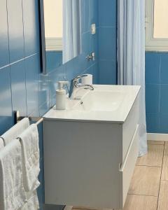 a bathroom with a white sink and a mirror at B&B Acqua Azzurra in Castellammare di Stabia