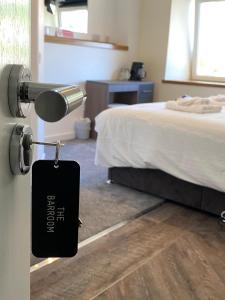 a doorhandle to a bedroom with a door tag on it at The Station Hotel in Insch