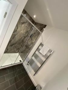uma cabina de duche ao nível do chão numa casa de banho com vidro em The Station Hotel em Insch