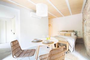 a room with a table and chairs and a bed at Aeris Boutique Studio in Girona +10 photos