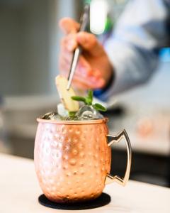 a person holding a cigarette in a cup with a plant at Lu' Hotel Porto Pino in SantʼAnna Arresi