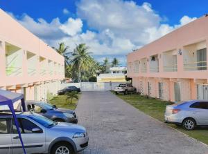 a row of cars parked in front of a building at Casa Arembepe in Camaçari
